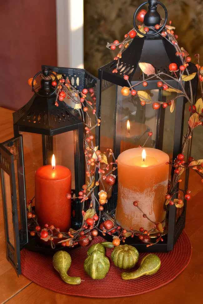 These two black metal lanterns have orange and red candles inside, which look so pretty when they are lit. The garland of small orange bittersweet berries wrapped all around the lanterns adds that natural, colorful fall touch.
