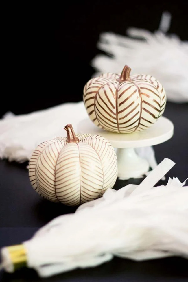 You can completely change the look of a plain white pumpkin by painting on some simple, shiny copper lines. This easy craft makes it look so modern and elegant.