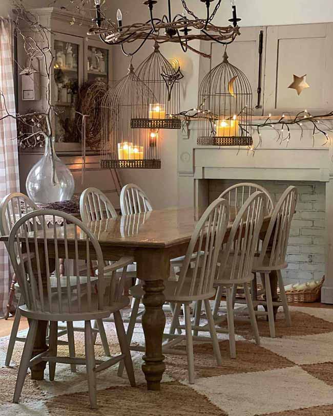 What a neat idea for the dining room! They used three hanging metal birdcages as lanterns, sitting candles on little trays inside the cages for a cool, moody look.