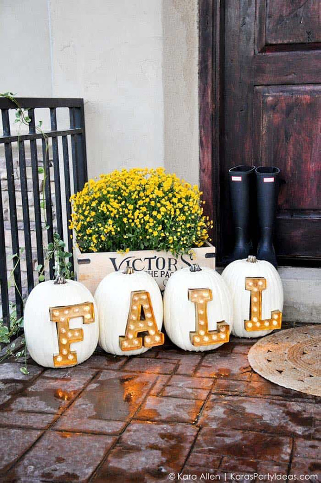 What an incredible way to welcome guests to your home! Carving letters into a row of large white pumpkins and lighting them up from inside creates a magical and festive sign for your front porch. This is a real showstopper.