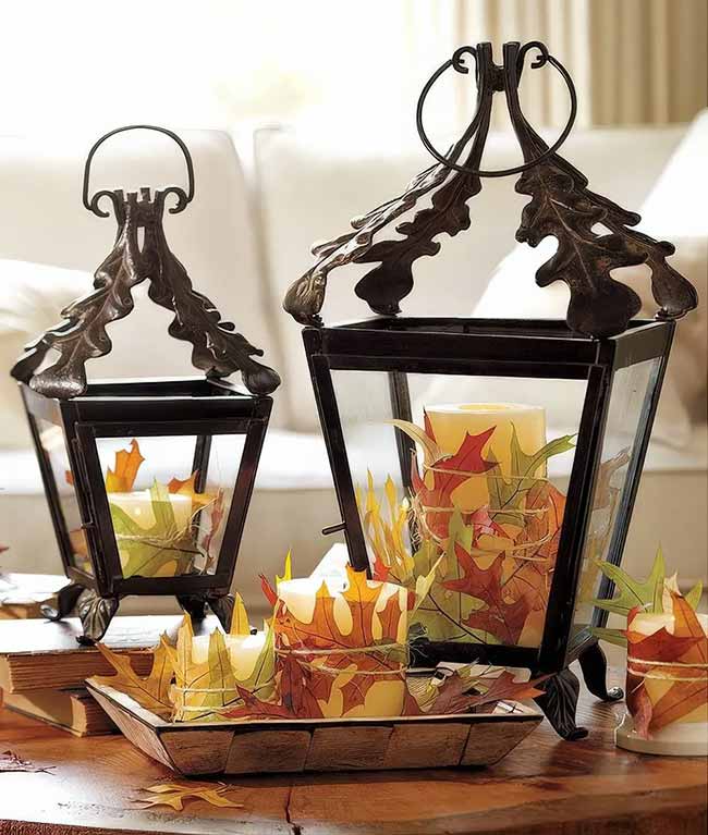These two metal lanterns are so pretty with the little feet and the oak leaf design on the top. Simply wrapping the candles with colorful fake leaves and placing them on a wooden tray is a great way to bring autumn color inside.