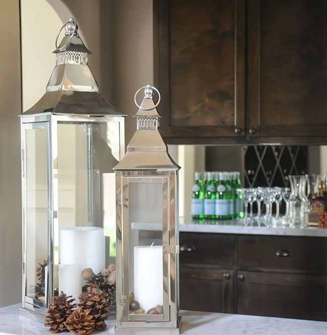 These modern, super shiny silver lanterns are a great choice for a classy look. Just adding a few pinecones and acorns around the base of the thick white candles is an easy, quick way to make them feel like fall.
