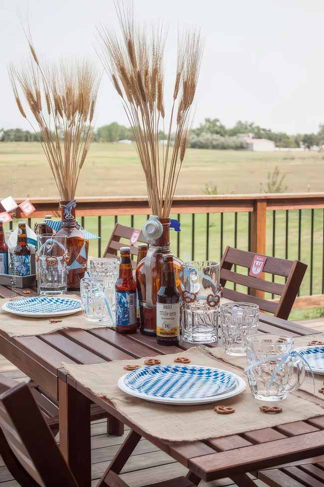 An Oktoberfest-themed table is such a cool idea for a fall party. Using beer bottles as vases for wheat is a simple but really clever centerpiece.