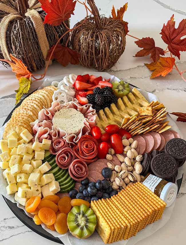 Wow, that is a perfect fall party charcuterie board! It has salami made into roses and so many bright colors, it's almost too pretty to eat.