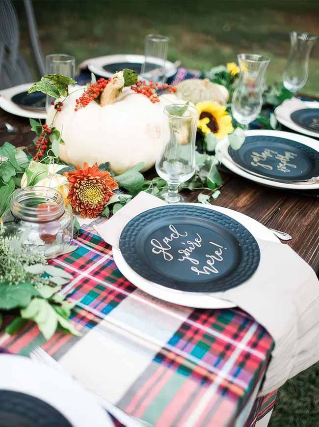 What a welcoming fall table setting! The message on the plate makes guests feel special, and the classic plaid tablecloth adds a cozy vibe.