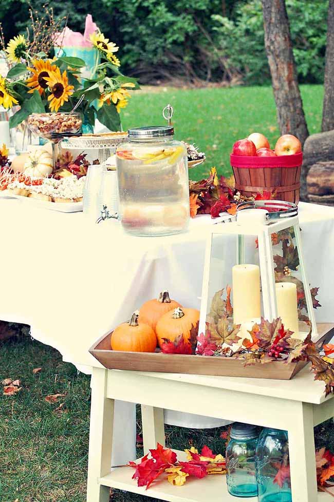 This whole outdoor buffet is giving off major fall festival vibes. With a big jug of infused water and plenty of snacks, it looks like the perfect setup for a casual get-together in the backyard.
