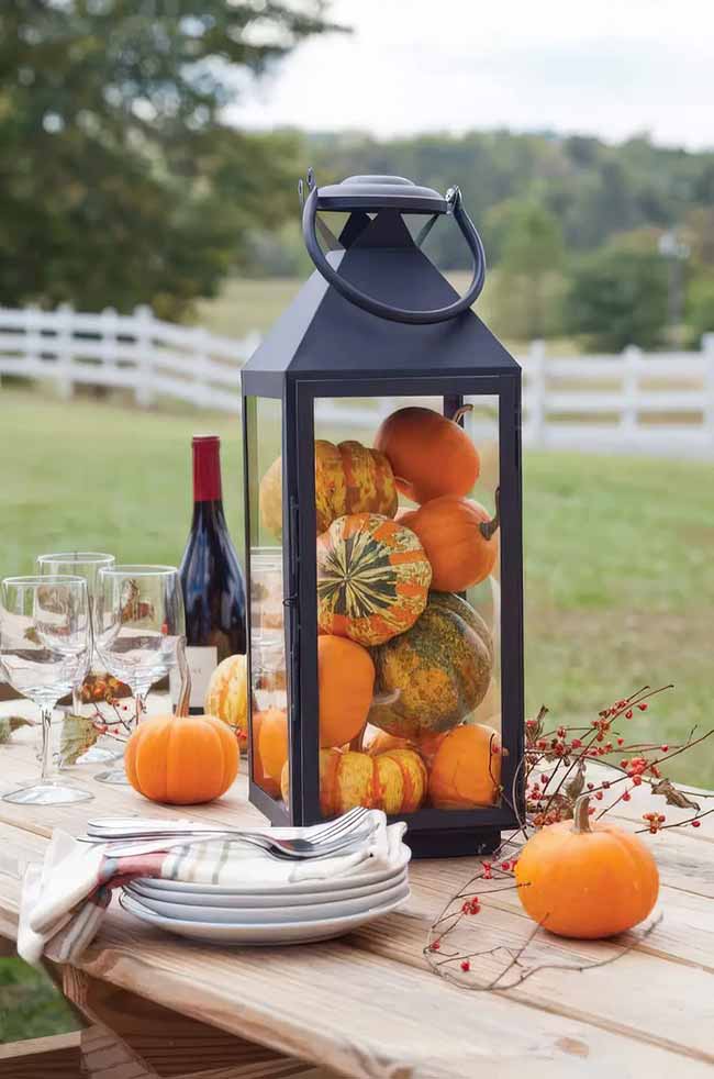 Simply filling a big lantern with mini pumpkins is a super easy and fast way to make a great centerpiece. This would look great on a picnic table or even on a front porch.