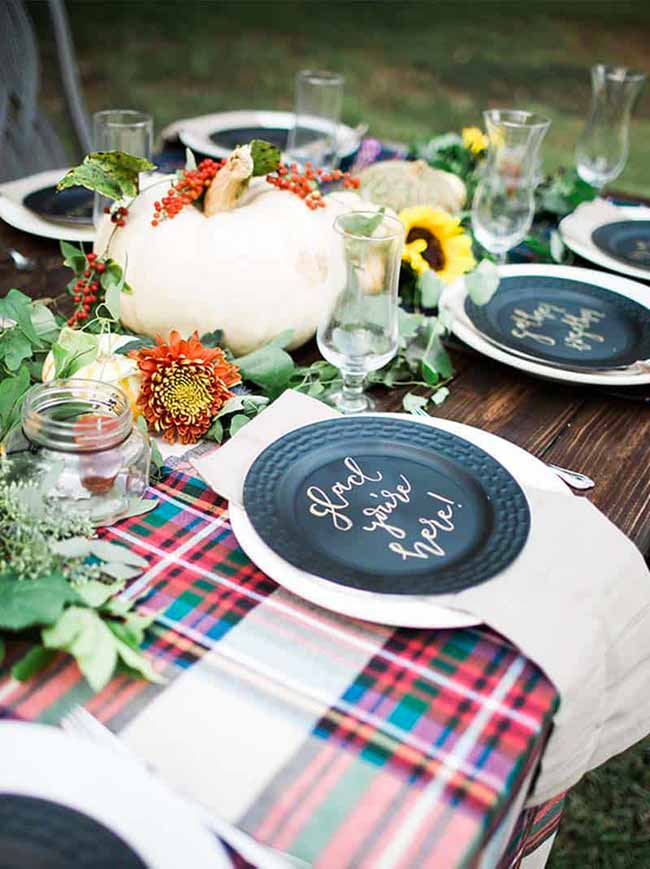 This tablescape is so inviting, from the warm plaid tablecloth to the handwritten message on the plate. It’s the small details that make a fall party feel extra special.