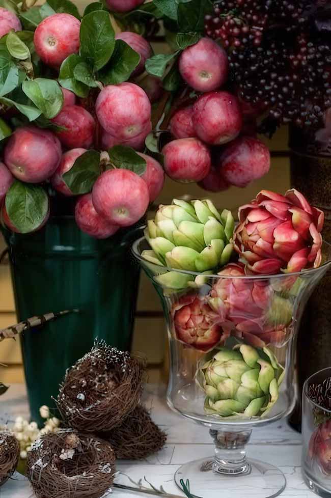 You don't always have to use pumpkins for fall decorating. This arrangement with deep red apples and artichokes looks so rich and elegant.