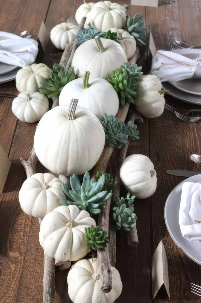 Pairing white pumpkins with succulents and driftwood creates such a cool and modern centerpiece. This is a great idea if you want a fall look that's not traditional.