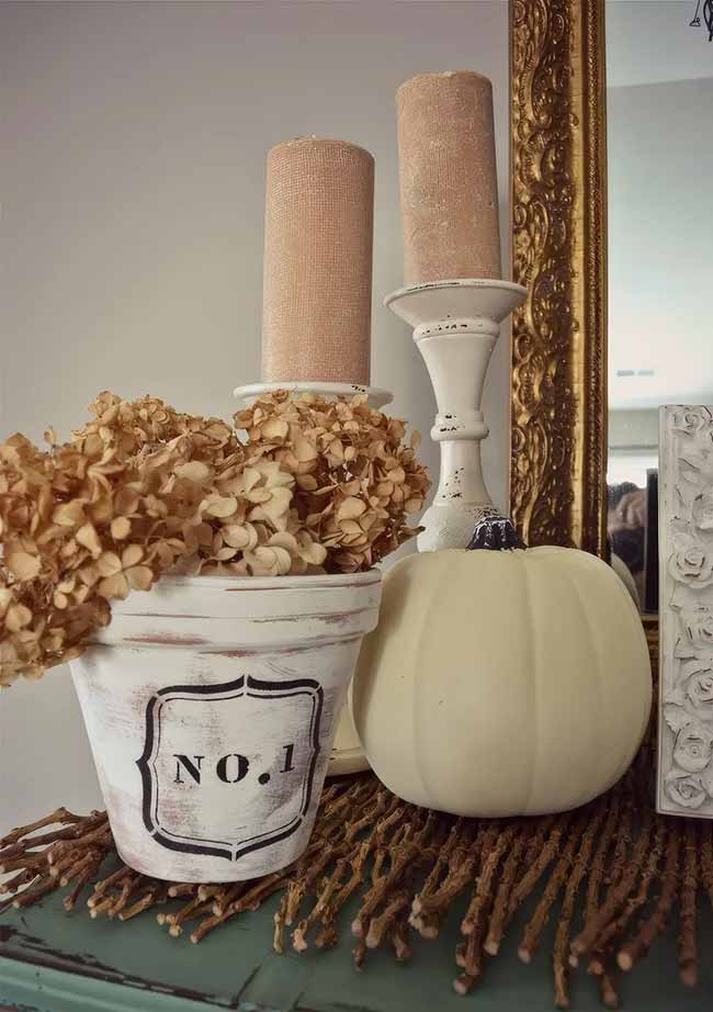 This is such a chic and subtle way to decorate for fall. The dried hydrangeas and white pumpkin create a really soft, vintage look that is super classy.