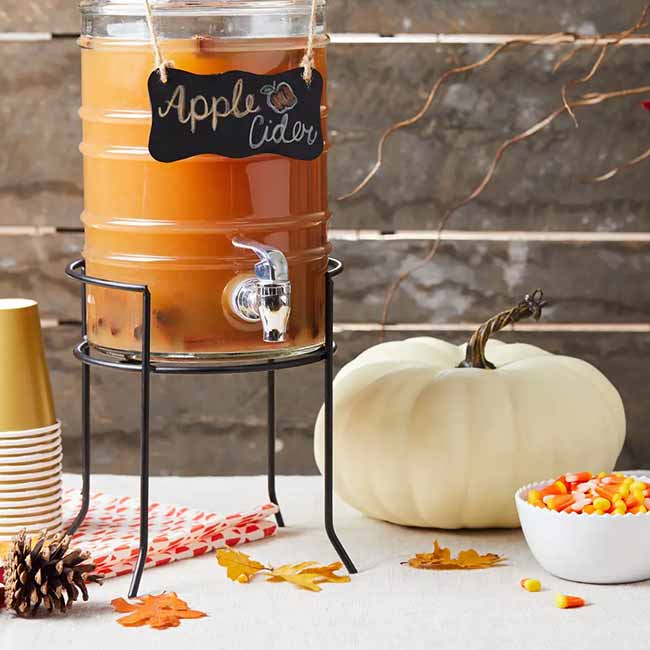 An apple cider station is a must-have for any fall party. It makes it so easy for guests to serve themselves, and it looks so festive next to the pumpkin and candy corn.