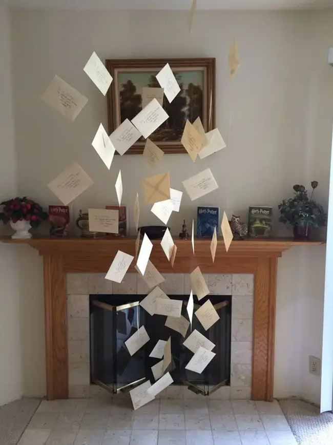 This is such a cool Harry Potter idea for Halloween! Hanging all those letters from the ceiling so they look like they are flying out of the fireplace is pure magic.