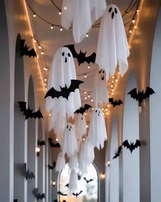 Look at all these cute ghosts and bats flying down the hallway! The string lights make this Halloween ceiling decoration feel extra special and not too scary.