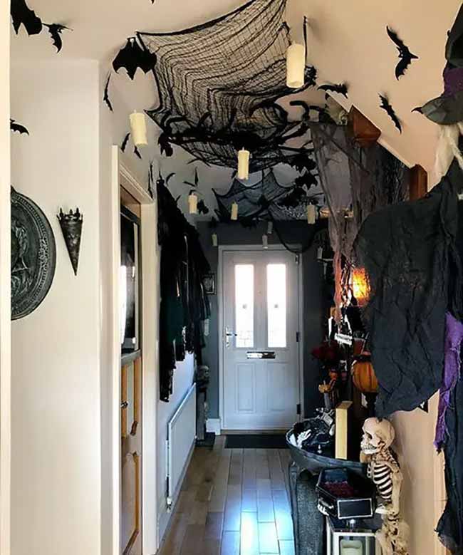 Wow, this hallway is so spooky. They covered the entire ceiling with black netting and bats. The hanging candles make it feel like you are walking through a haunted house.