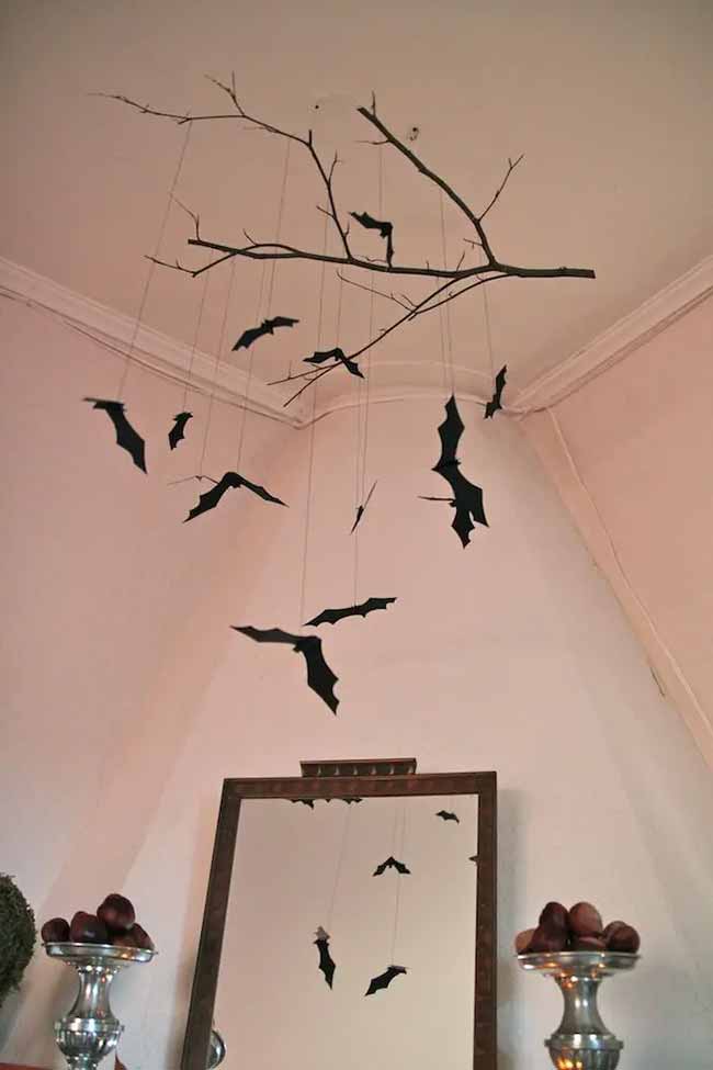 This is a very cool and simple DIY decoration. Someone just hung a real branch from the ceiling and added paper bats. It's a great, spooky mobile.