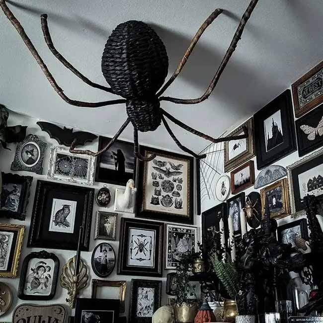 That is a huge spider on the ceiling! It fits in perfectly with all the spooky art on the walls. What a creative and creepy way to decorate a corner.
