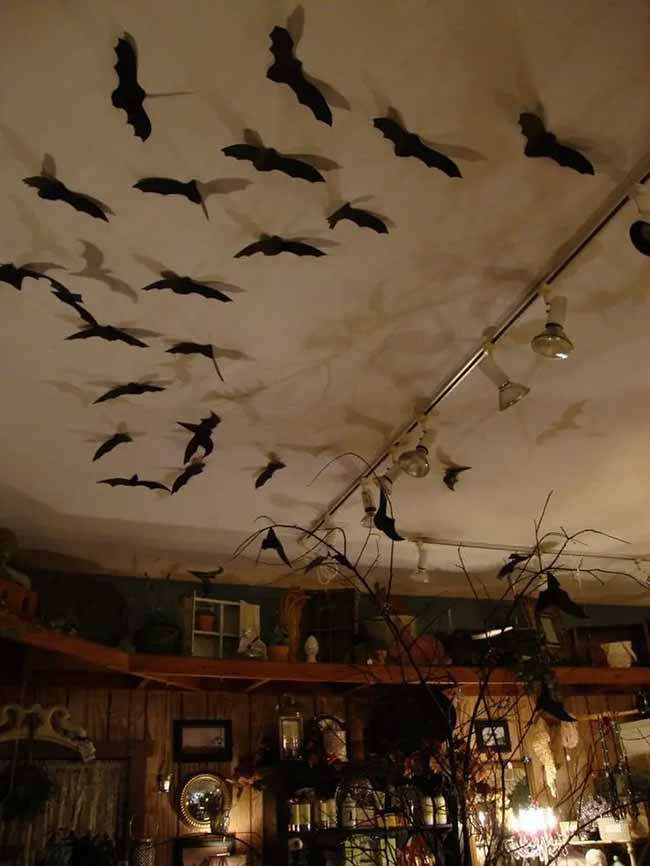 Taping paper bats all over the ceiling is such a classic Halloween trick. The lights make awesome shadows, which makes it look like even more bats are flying around.