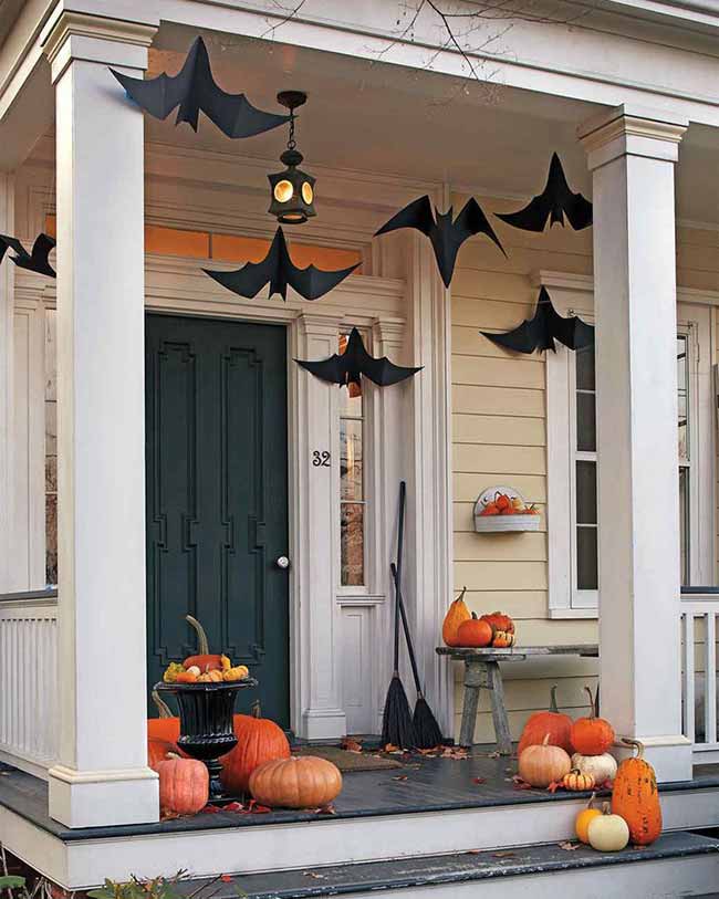 Hanging a few big bats from the porch ceiling is a simple way to make your front door look spooky. It's the perfect Halloween decoration to welcome trick-or-treaters.