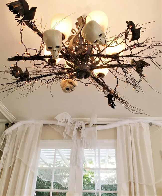 Wow, they really turned their light into a scary Halloween centerpiece! Adding all those branches, skulls, and crows to the chandelier is a genius idea.