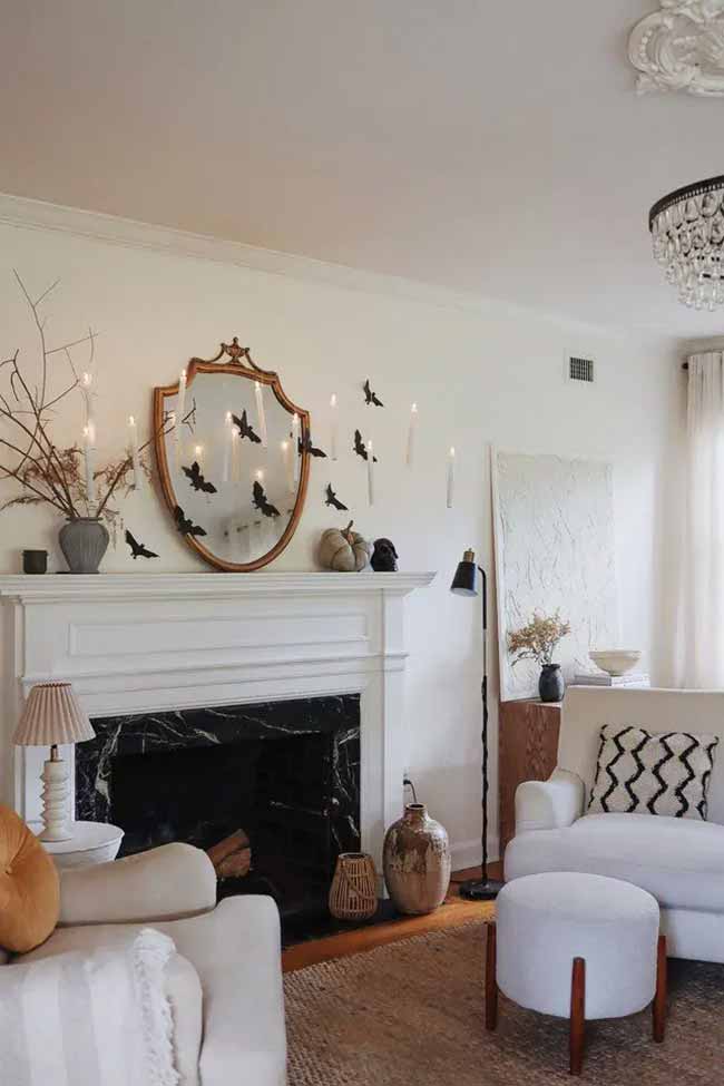 This is a smart way to get the floating look. They stuck the bats and candles right onto the mirror and wall. It's a really classy and spooky Halloween decoration for the living room.