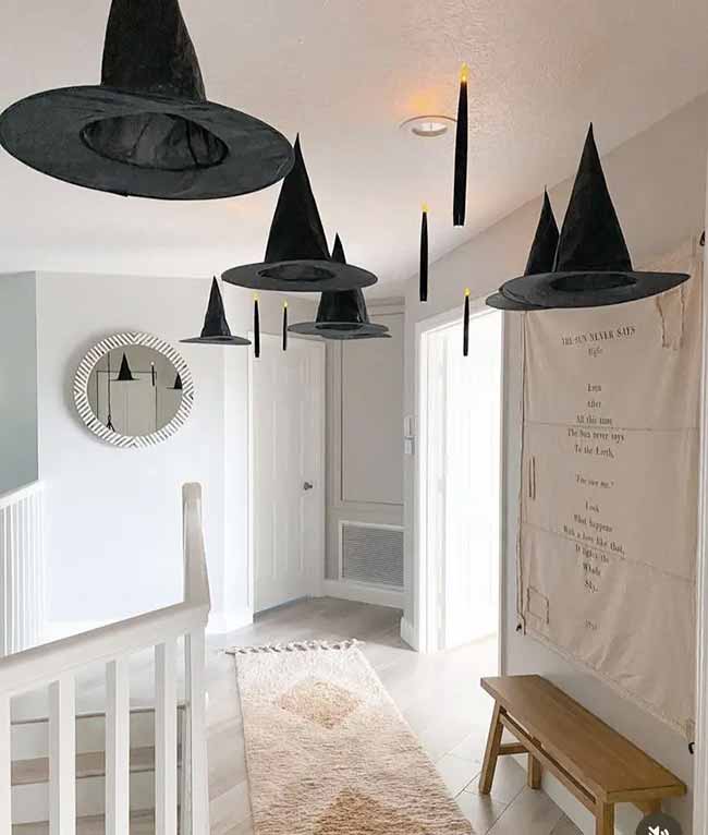 This hallway looks so magical with floating witch hats and candles hanging from the ceiling.
