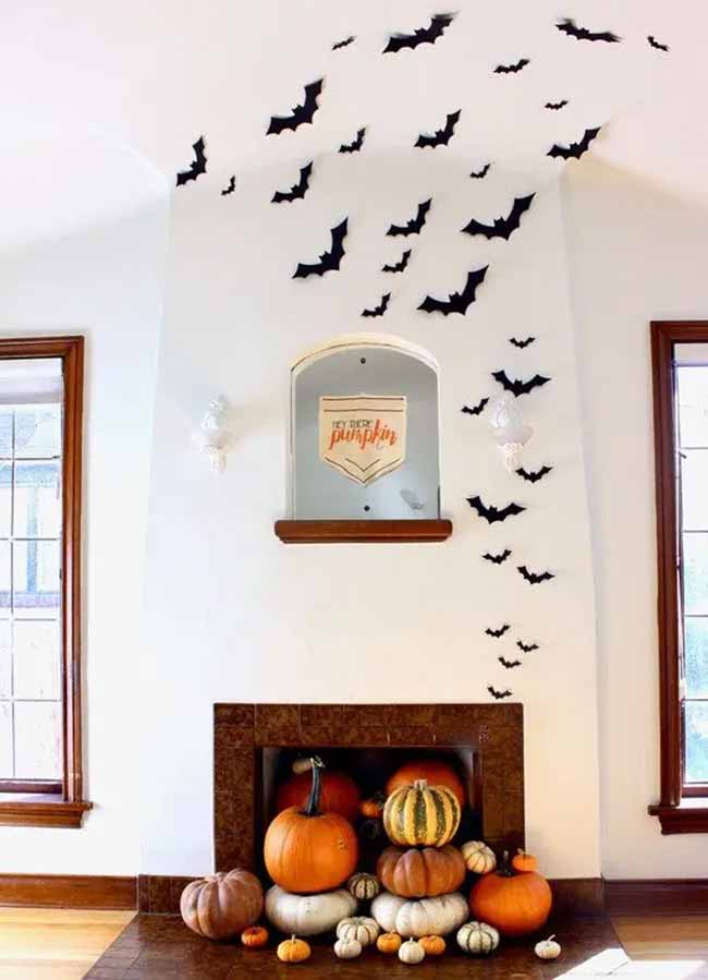 This is such a cool idea! It looks like a cloud of bats is flying right out of the fireplace and onto the ceiling.
