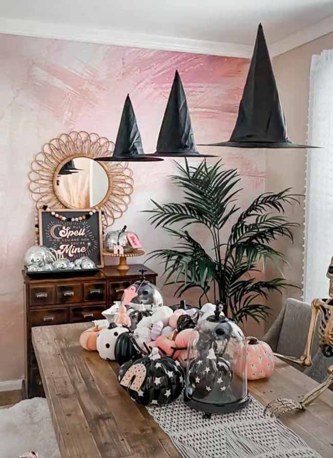 This proves Halloween can be pink! Hanging the witch hats from the ceiling is the perfect spooky touch for this cute table.