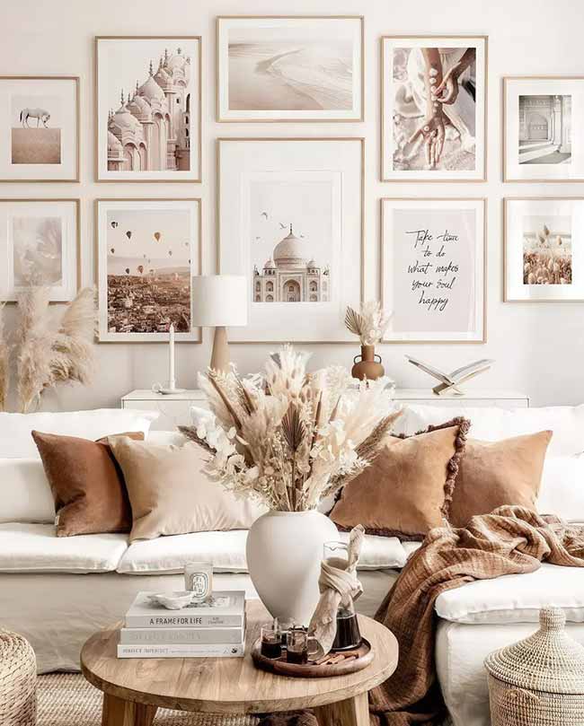 This room is all about soft neutrals and pampas grass! The gallery wall with all the light, travel-themed photos makes the room feel calm and airy. The burnt orange velvet pillows add just enough warm color for the season.
