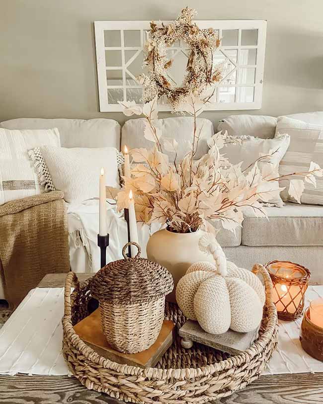 This room is very soft and cozy with all the cream and white colors. That big knitted pumpkin and the woven acorn basket on the tray are adorable. The dried white leaves and wreath are a nice twist on fall decor.