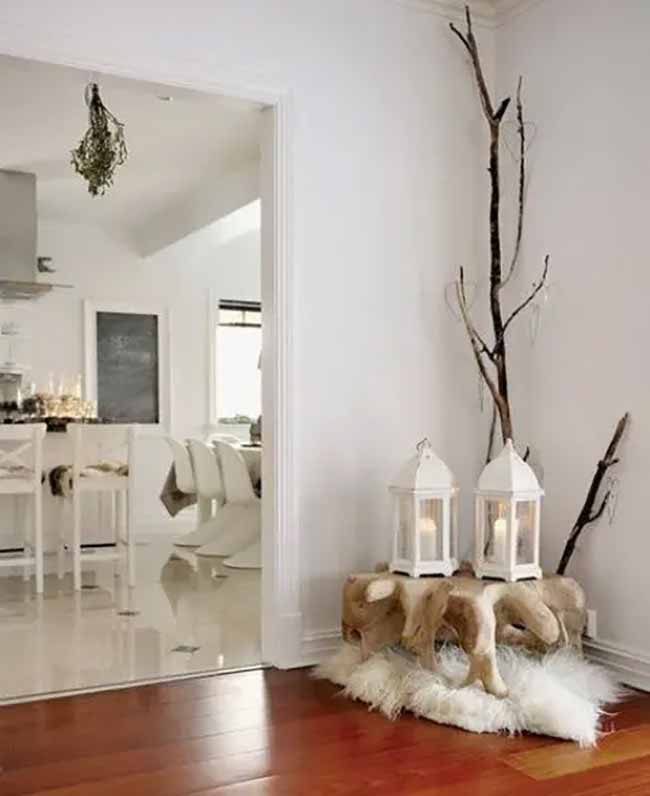 Bright Corner Decor. White lanterns and tall, simple branches make a super clean but cozy corner display. Placing it on that fluffy white rug really makes the wood floor shine.