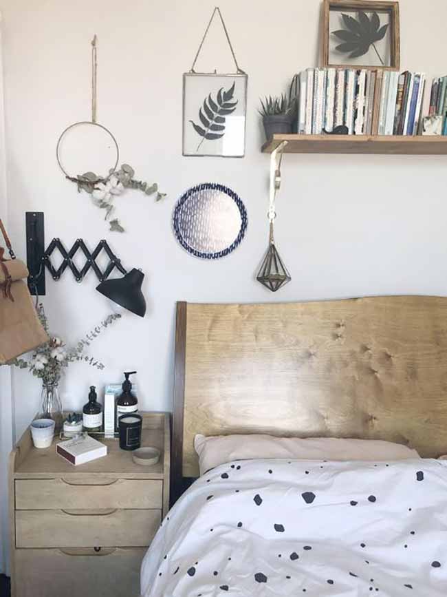 Bedroom Simplicity. The natural wood headboard is beautiful and simple in this bright room. The small, round mirror and pressed leaves in frames keep the wall light and interesting to look at.