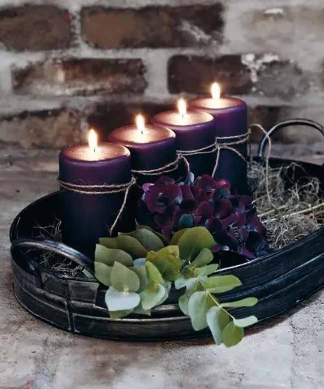 Dark Candle Display. The deep purple candles wrapped in simple twine look beautiful against the rustic brick wall. The dark metal tray and the moody flowers make this a very cozy and dramatic fall setup.