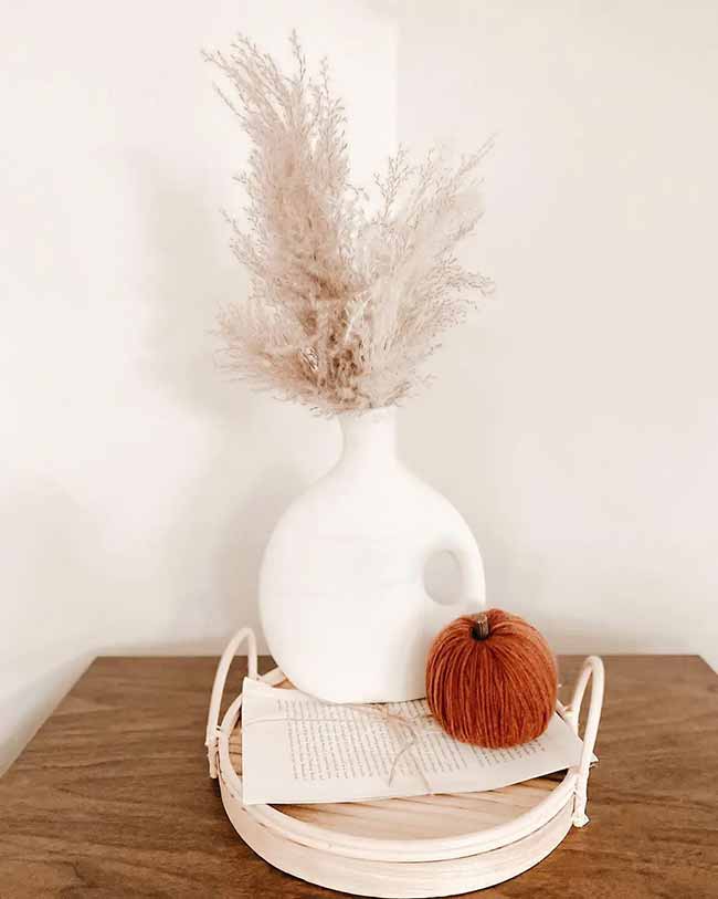 Fluffy Pampas Grass. The fluffy, light pink grass in the simple white jug vase creates a very soft and airy look.