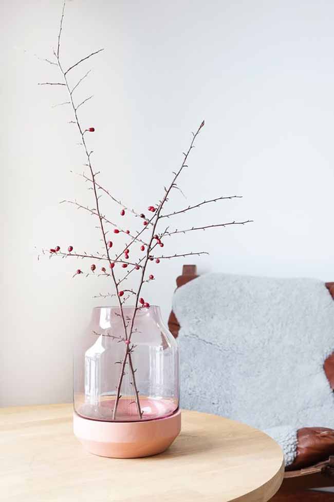Pink and Berry Vase. The simple glass vase with a pale pink base looks so pretty holding the thorny branches with tiny red berries. The soft gray sheepskin on the leather chair makes this a very comfortable spot.