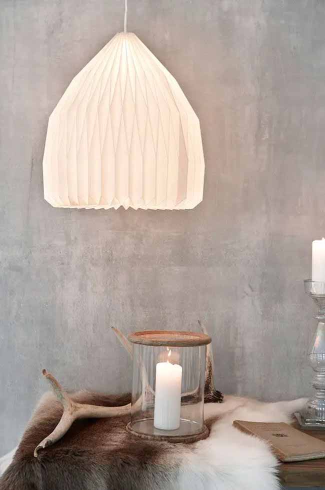 Pleated Light Fixture. The folded paper lamp is a lovely, classic Scandinavian design. The rustic glass lantern and fur hide below provide a cozy contrast to the modern light fixture.