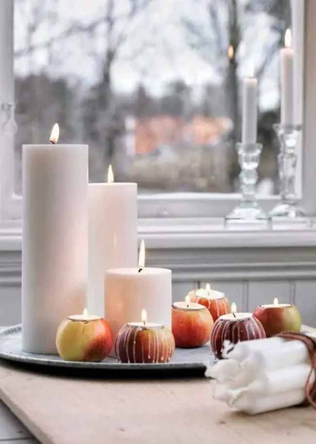 Apple Candle Holders. Large white candles sit next to small candle holders cleverly made from cored apples. This is a charming, simple idea for a seasonal table.