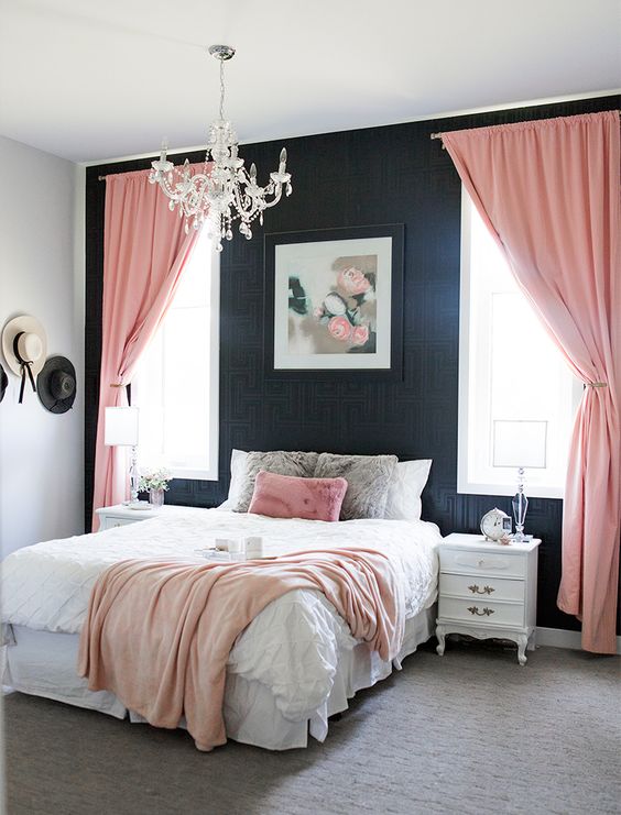 That crystal chandelier adds so much sparkle to the black patterned wallpaper. This is a very fancy pink and black bedroom.