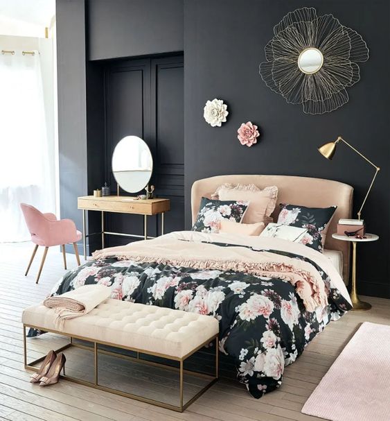 Floral patterns on the dark bedding look lovely with the gold furniture legs. This pink and black bedroom is sweet and stylish.