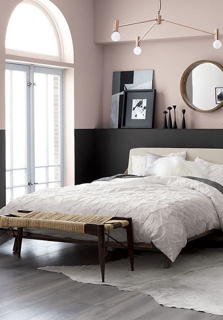 Painting the bottom half of the wall black and the top pink is such a clever design idea. It gives this pink and black bedroom a very modern and airy feeling with that big arched window.
