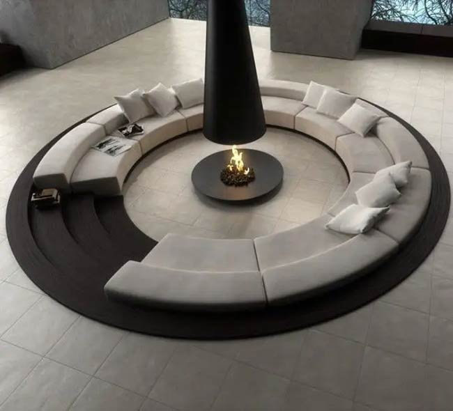 A white sofa makes a perfect circle around a central fire pit in this very modern conversation pit.