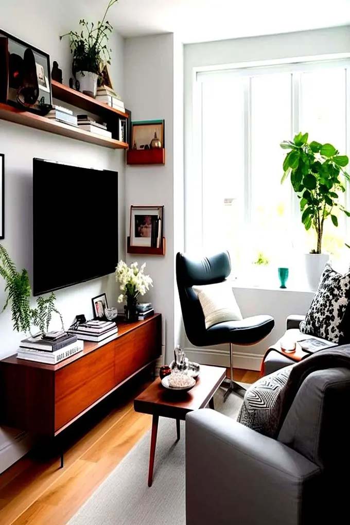 This wall is full of life with all the climbing vines and hanging plants surrounding the screen. Wood slice art and a geometric deer head add to the wild, natural vibe. It is a very bold and green TV wall decor choice for plant lovers.