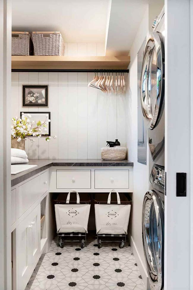 In this Minneapolis home, a sliding pocket door hides the stacked washer and dryer, keeping the area clean and streamlined. Built-in shelves, a drying rack, and a utility sink make chores easier, while rolling hampers help sort laundry efficiently. When closed, the space disappears from view, giving a tidy look to the hallway. Clever features like this prove that functionality and design can coexist beautifully in small laundry closets.